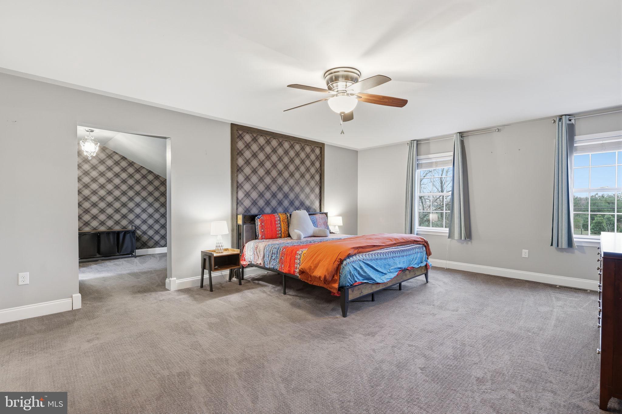 3852 Dark Hollow Road Furlong, PA 18925 - Photo 36 of 52 a bedroom with a bed and a chandelier