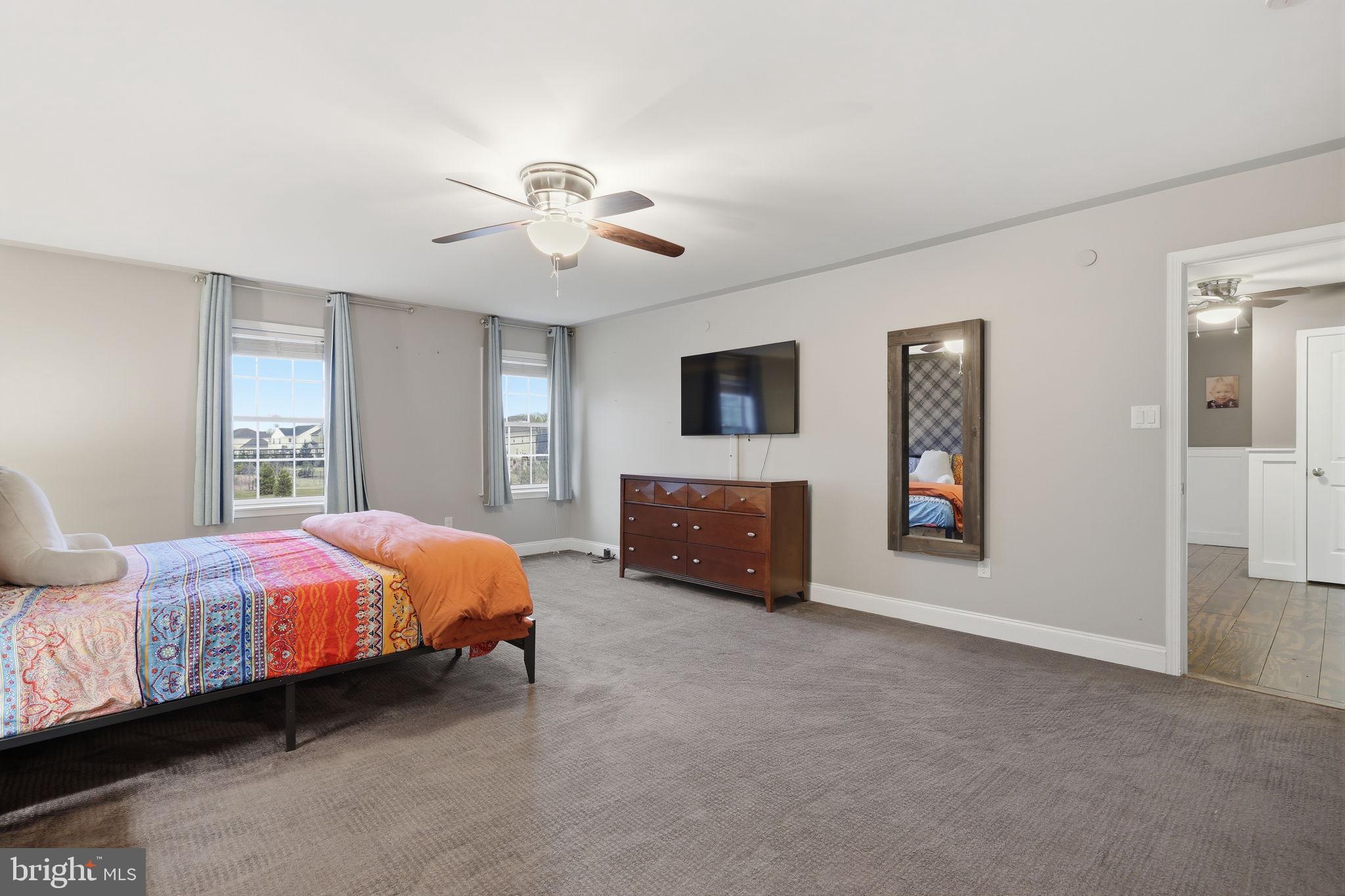3852 Dark Hollow Road Furlong, PA 18925 - Photo 37 of 52 a spacious bedroom with a bed and a chandelier