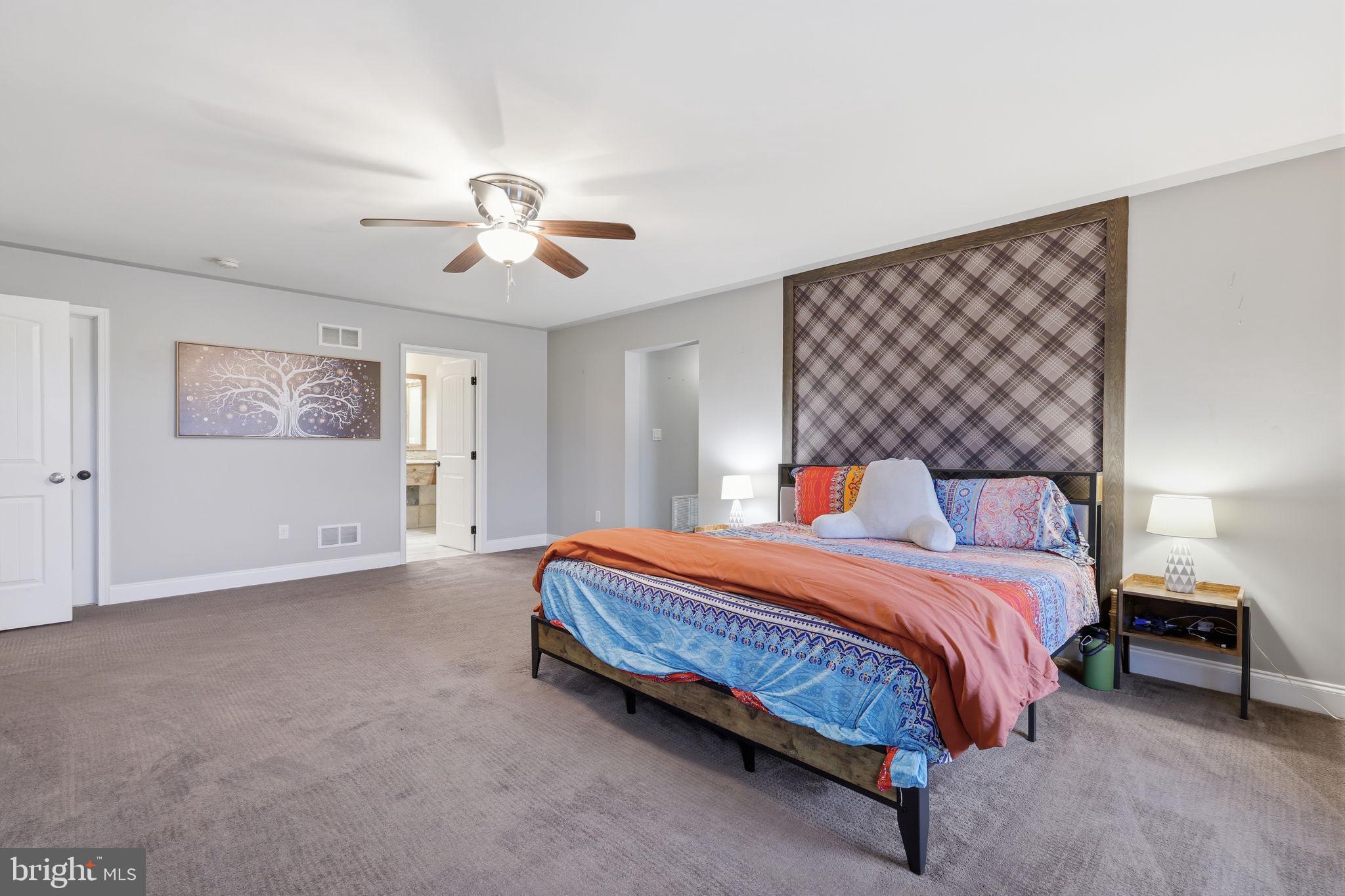 3852 Dark Hollow Road Furlong, PA 18925 - Photo 38 of 52 a bedroom with a bed and a chandelier