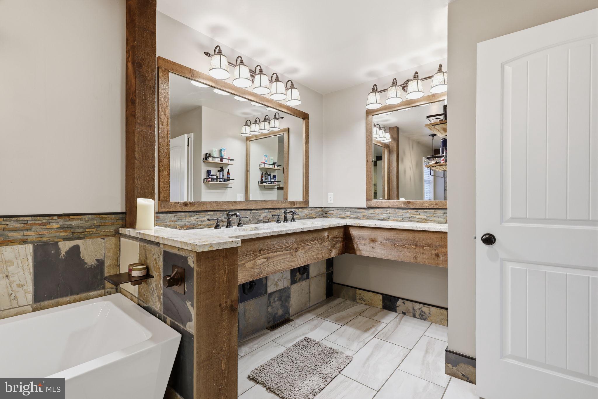 3852 Dark Hollow Road Furlong, PA 18925 - Photo 42 of 52 a bathroom with a sink a vanity and a mirror
