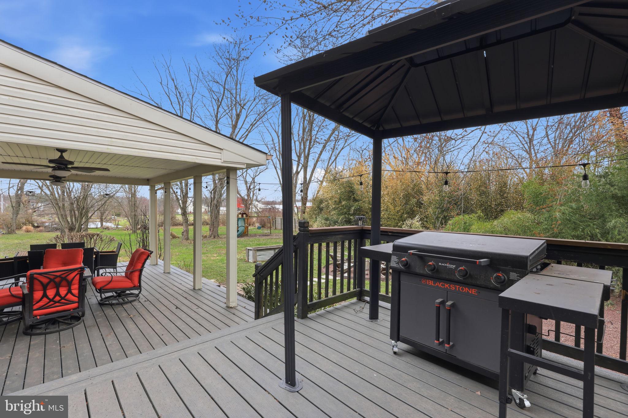 3852 Dark Hollow Road Furlong, PA 18925 - Photo 46 of 52 a view of roof deck with table and chairs and wooden floor