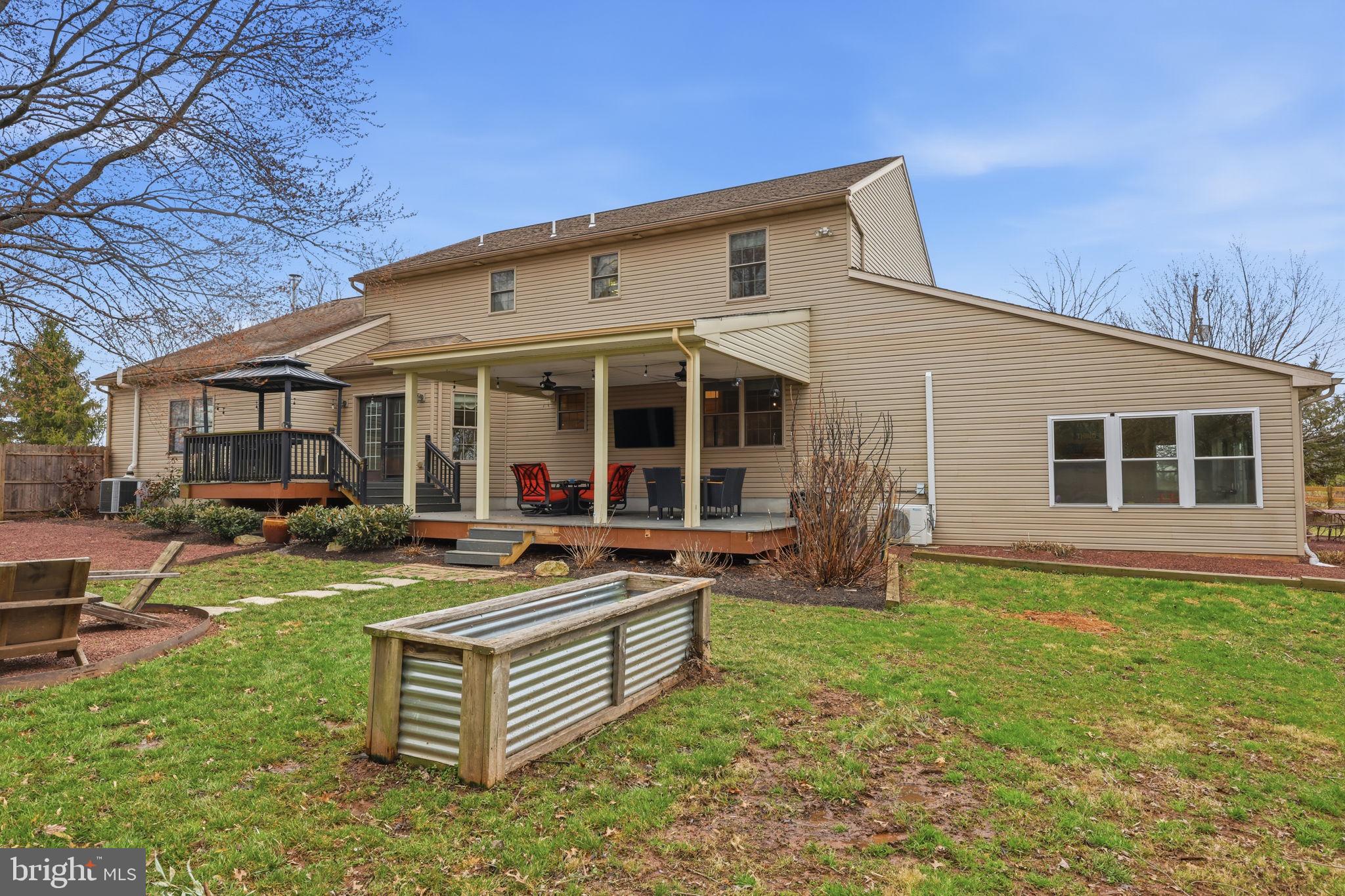 3852 Dark Hollow Road Furlong, PA 18925 - Photo 48 of 52 a view of a house with backyard sitting area and garden
