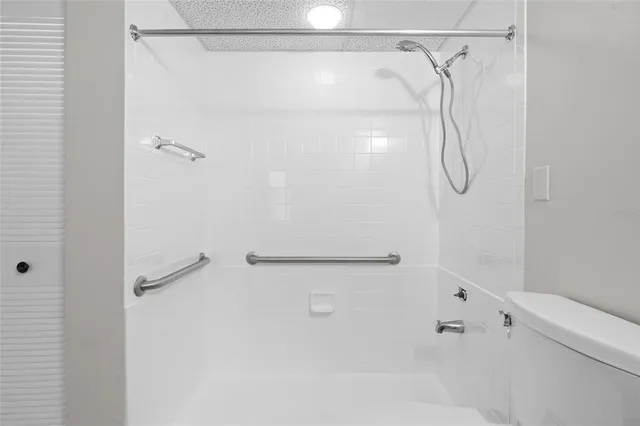 a bathroom with a shower and a shower