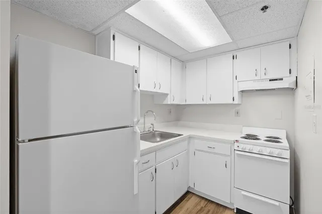 a white refrigerator freezer sitting inside of a kitchen