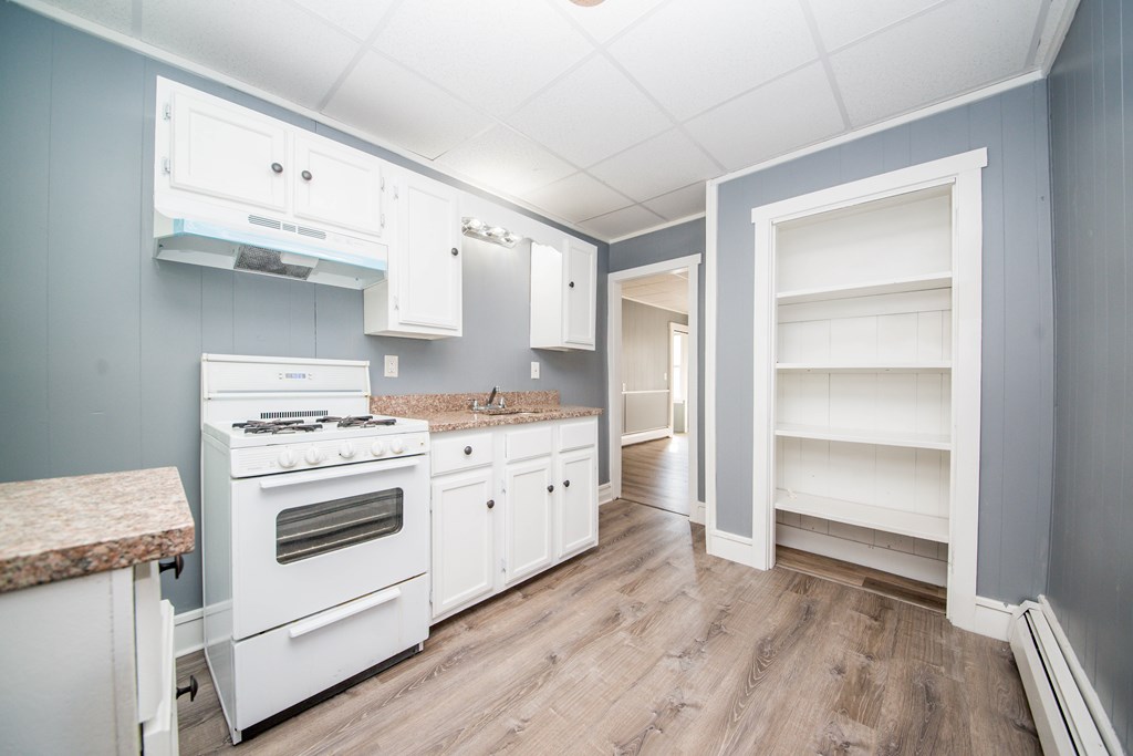 130 Baker Street Fall River, MA 02721 - Photo 11 of 21 a kitchen with a stove cabinets and wooden floor