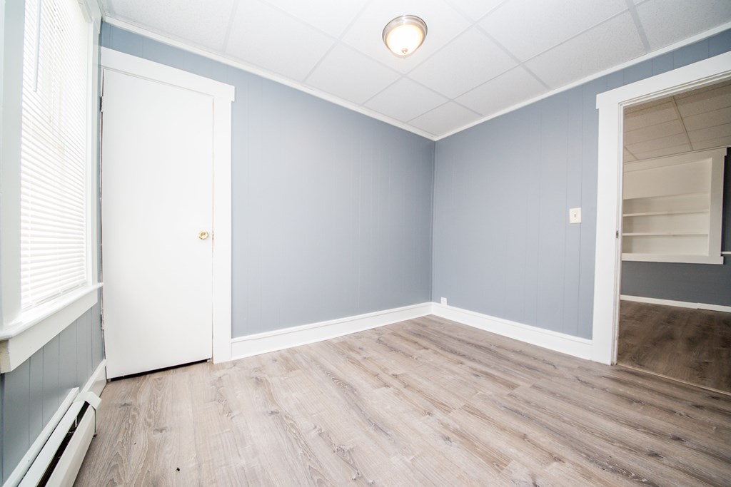 130 Baker Street Fall River, MA 02721 - Photo 13 of 21 an empty room with wooden floor and windows