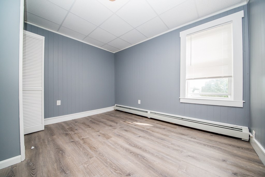 130 Baker Street Fall River, MA 02721 - Photo 14 of 21 an empty room with wooden floor and windows