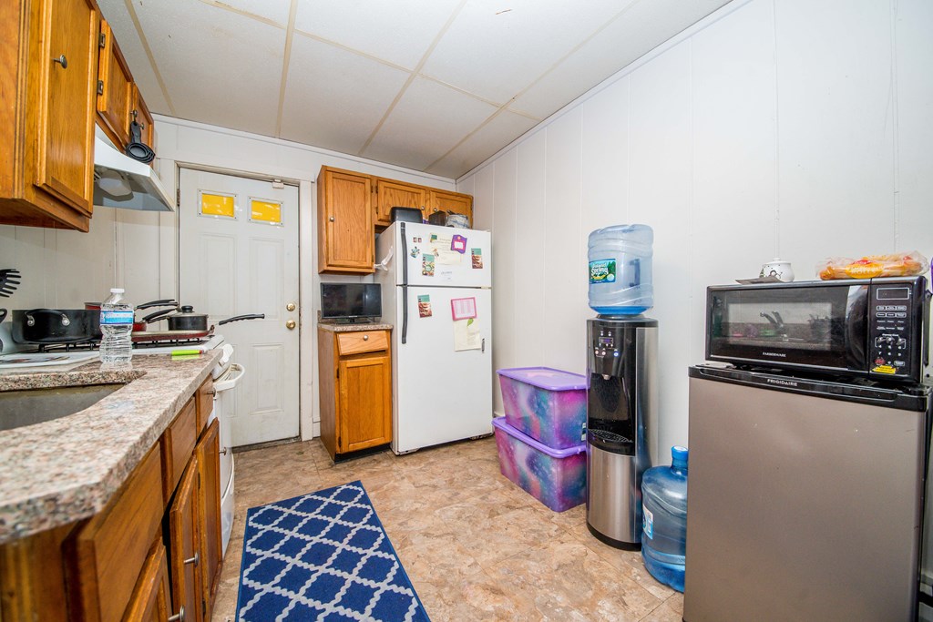 130 Baker Street Fall River, MA 02721 - Photo 20 of 21 a kitchen that has a lot of cabinets a sink and a stove