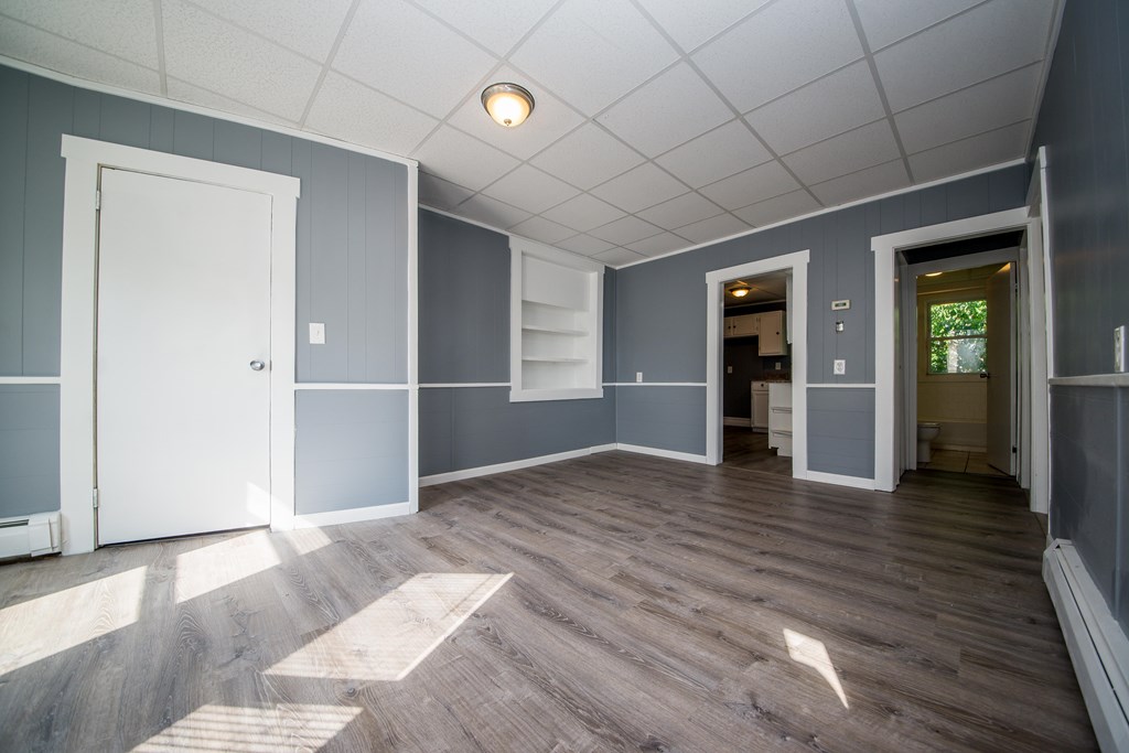 130 Baker Street Fall River, MA 02721 - Photo 6 of 21 an empty room with wooden floor and windows