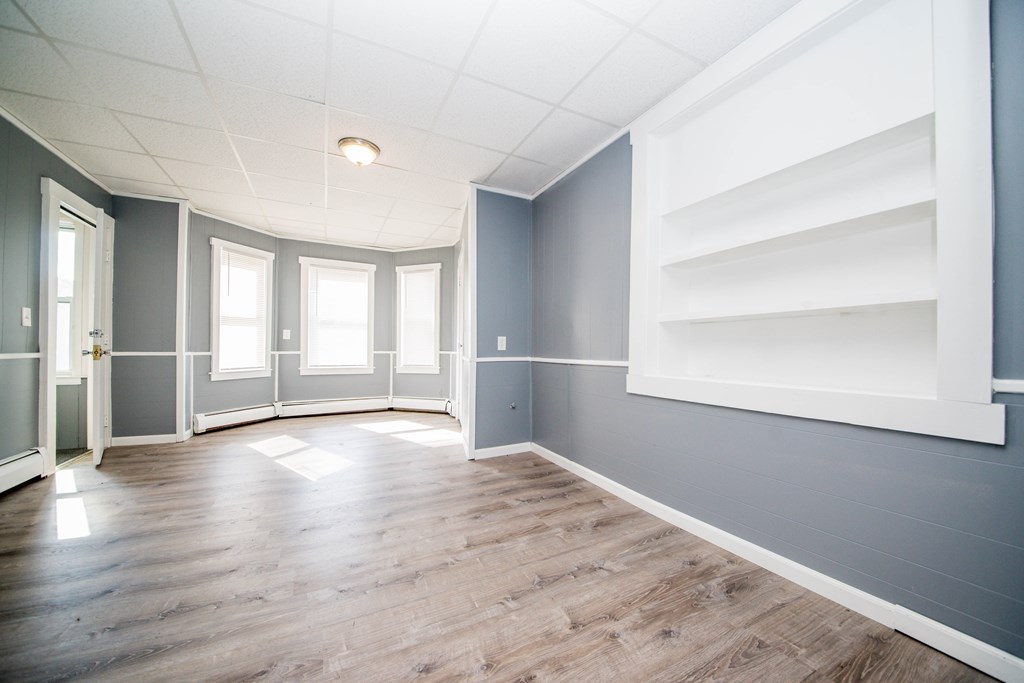 130 Baker Street Fall River, MA 02721 - Photo 8 of 21 wooden floor in an empty room with a window