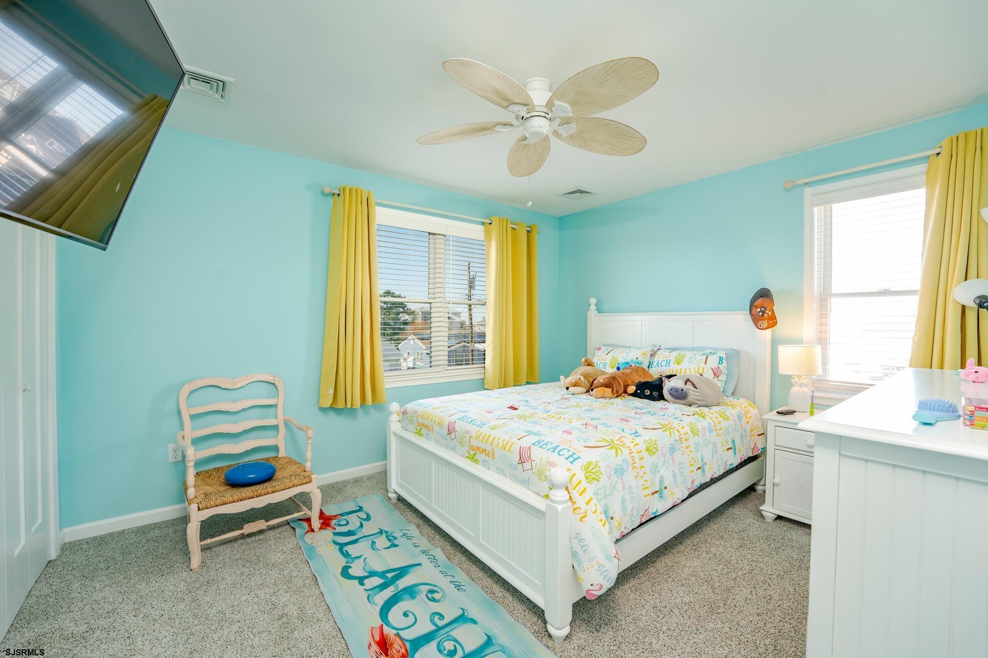 703 Bobby Jones Road Brigantine, NJ 08203 - Photo 15 of 34 a bedroom with a bed and a chandelier