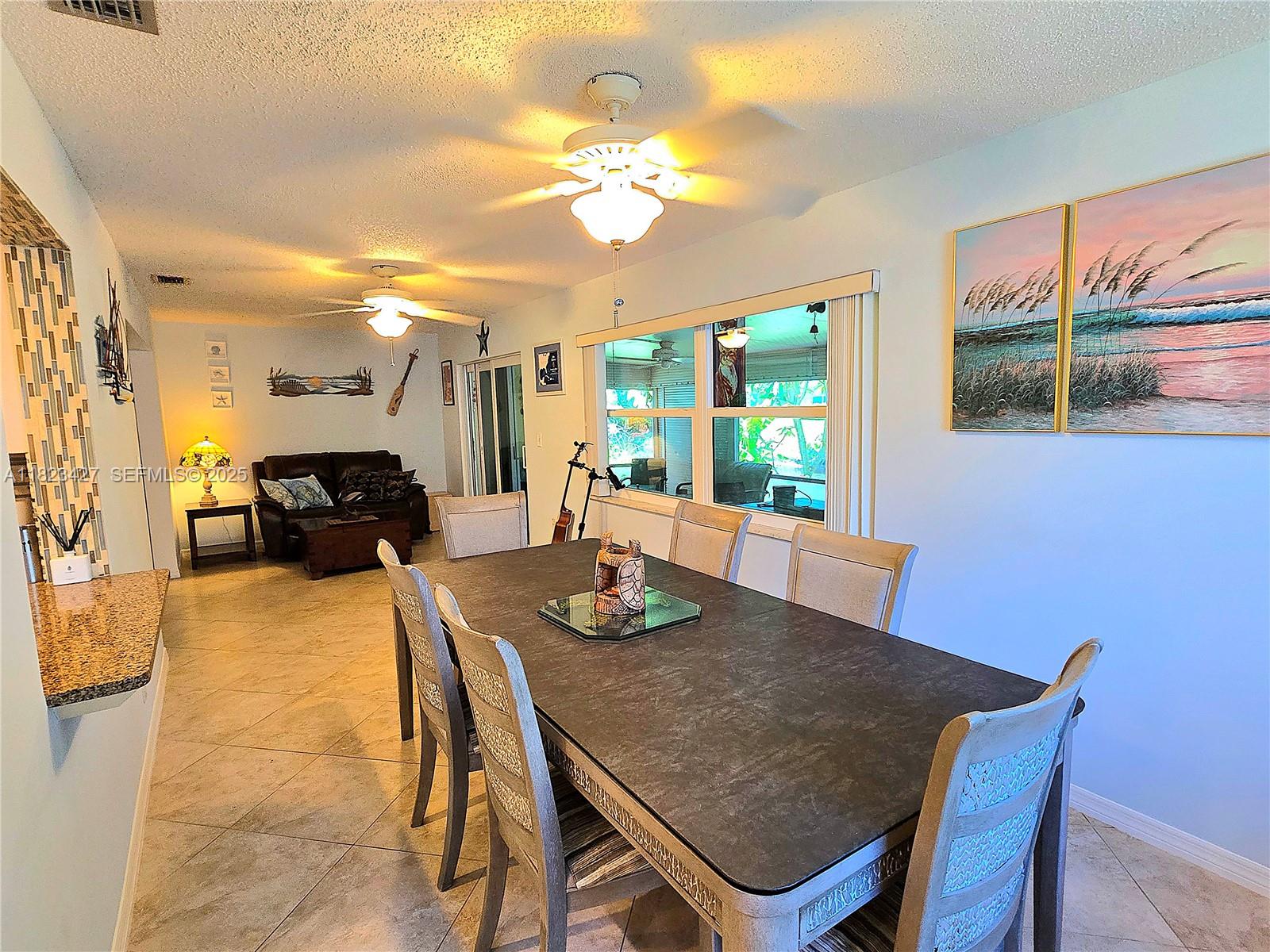 1711 Southwest 22nd Street Boynton Beach, FL 33426 - Photo 16 of 60 a view of a dining room with furniture and a chandelier