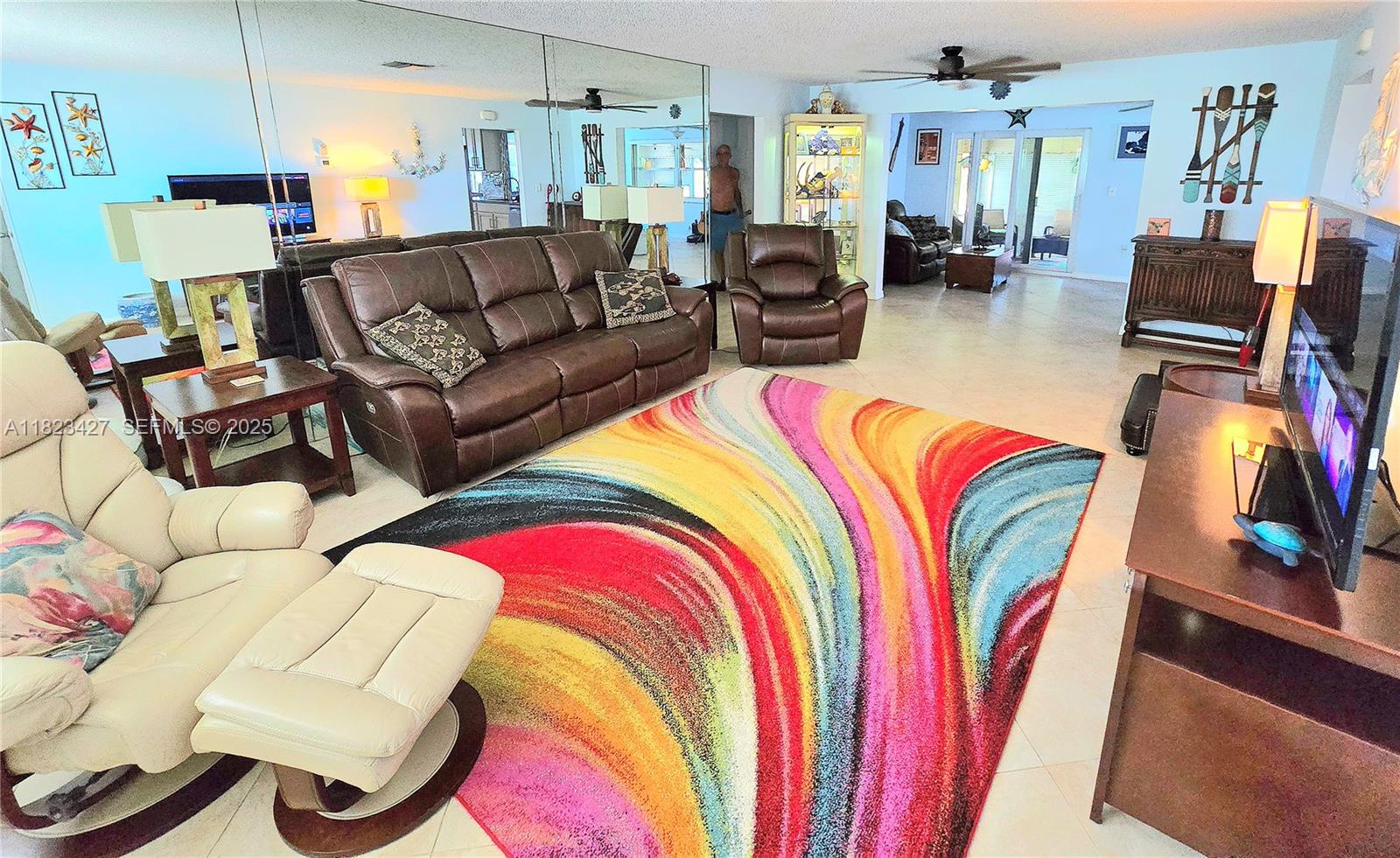 1711 Southwest 22nd Street Boynton Beach, FL 33426 - Photo 2 of 60 a living room with furniture and a flat screen tv