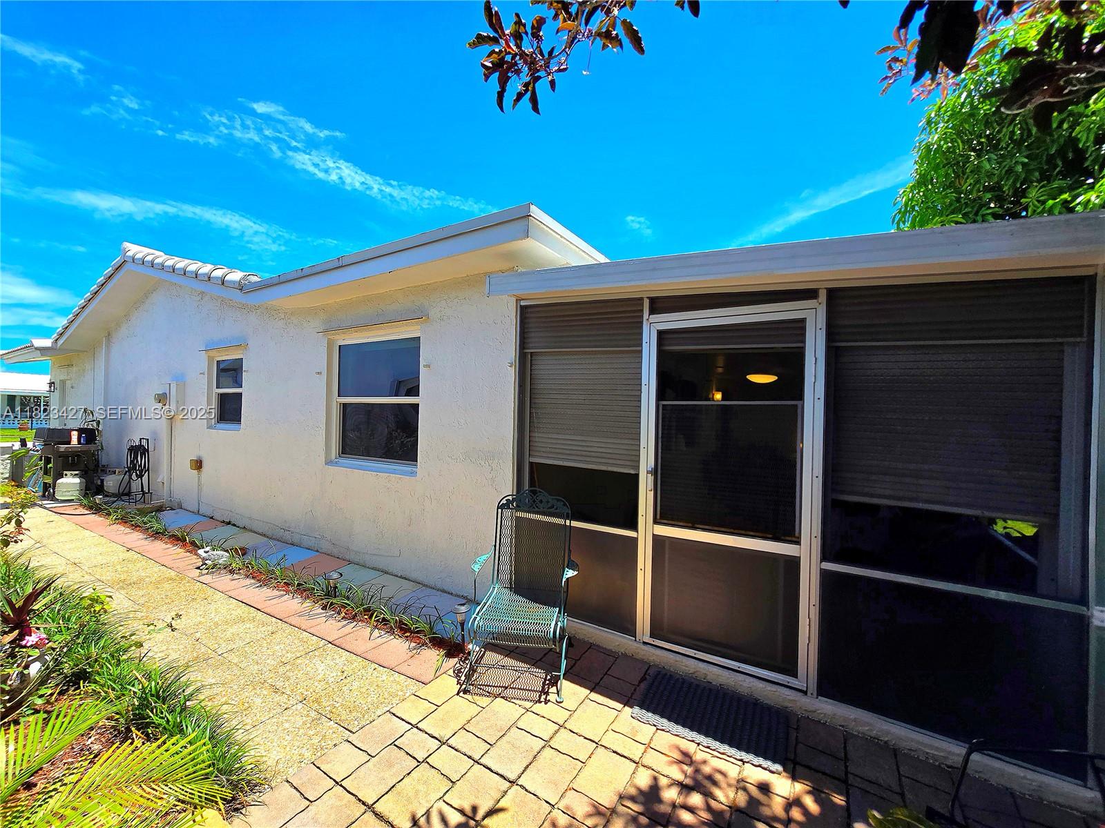 1711 Southwest 22nd Street Boynton Beach, FL 33426 - Photo 22 of 60 a front view of a house with a large window