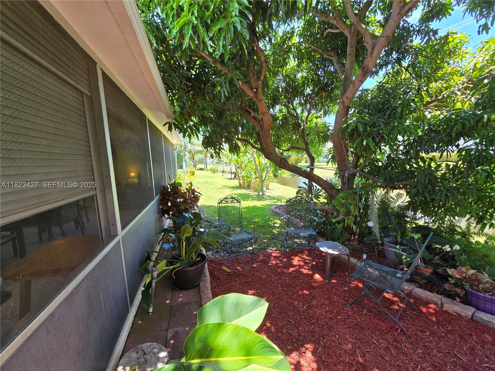 1711 Southwest 22nd Street Boynton Beach, FL 33426 - Photo 24 of 60 a backyard of a house with outdoor seating