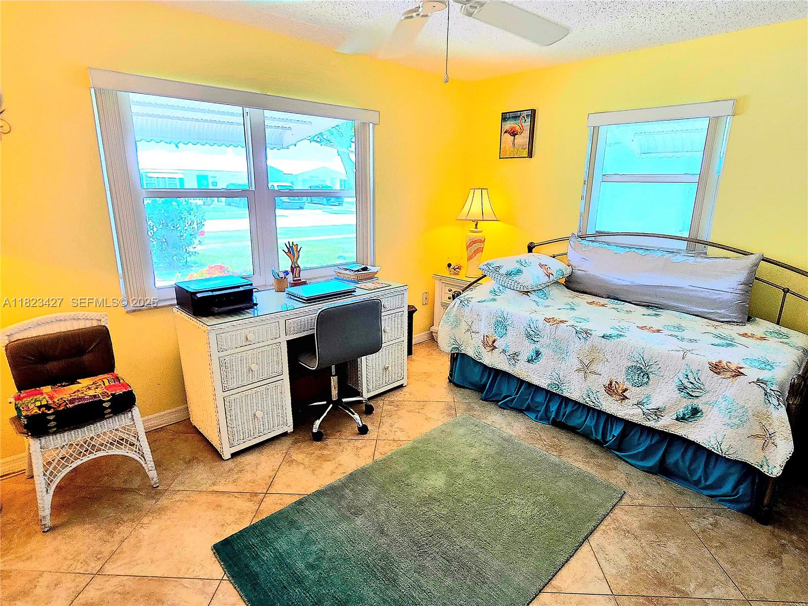 1711 Southwest 22nd Street Boynton Beach, FL 33426 - Photo 32 of 60 a bedroom with a bed and a window