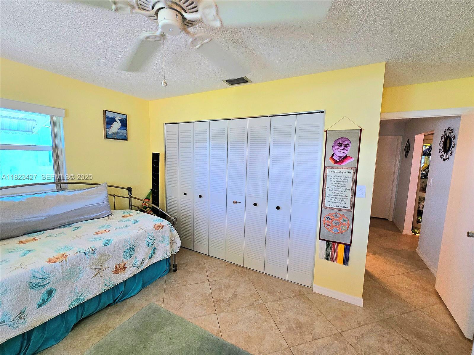 1711 Southwest 22nd Street Boynton Beach, FL 33426 - Photo 33 of 60 a bedroom with a bed and a view of bathroom