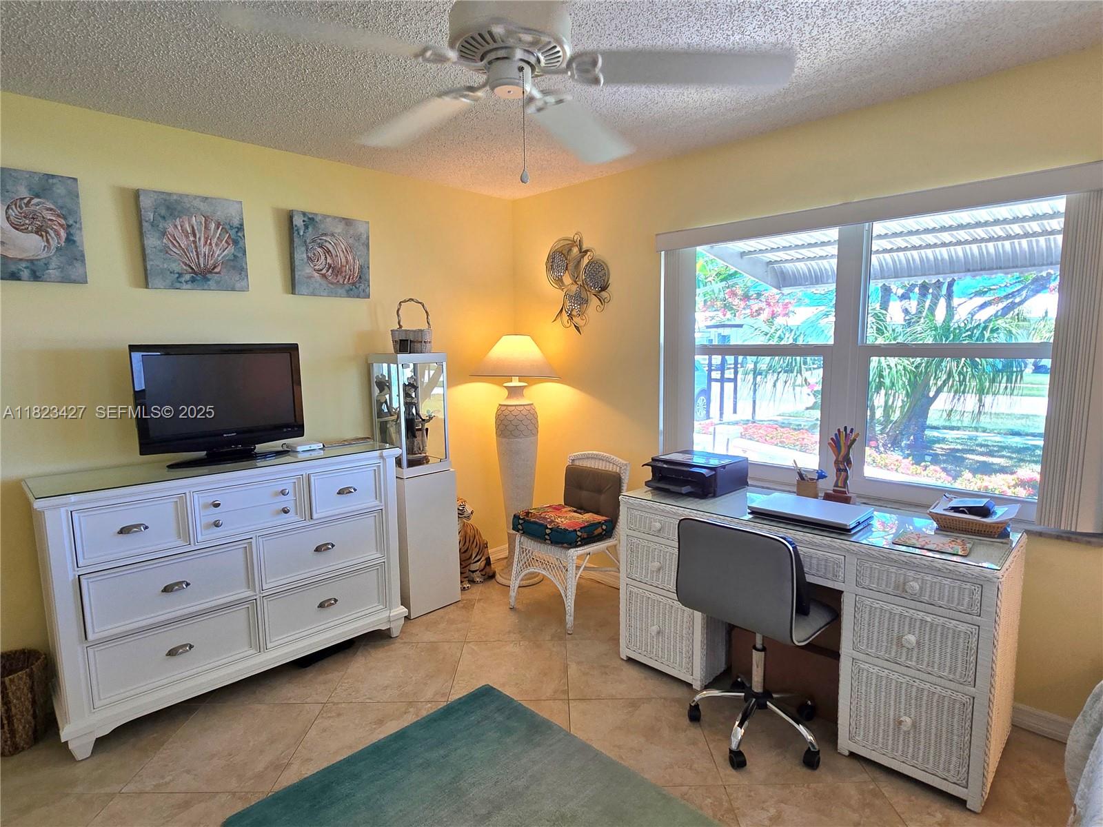 1711 Southwest 22nd Street Boynton Beach, FL 33426 - Photo 34 of 60 a view of a workspace with furniture and a window