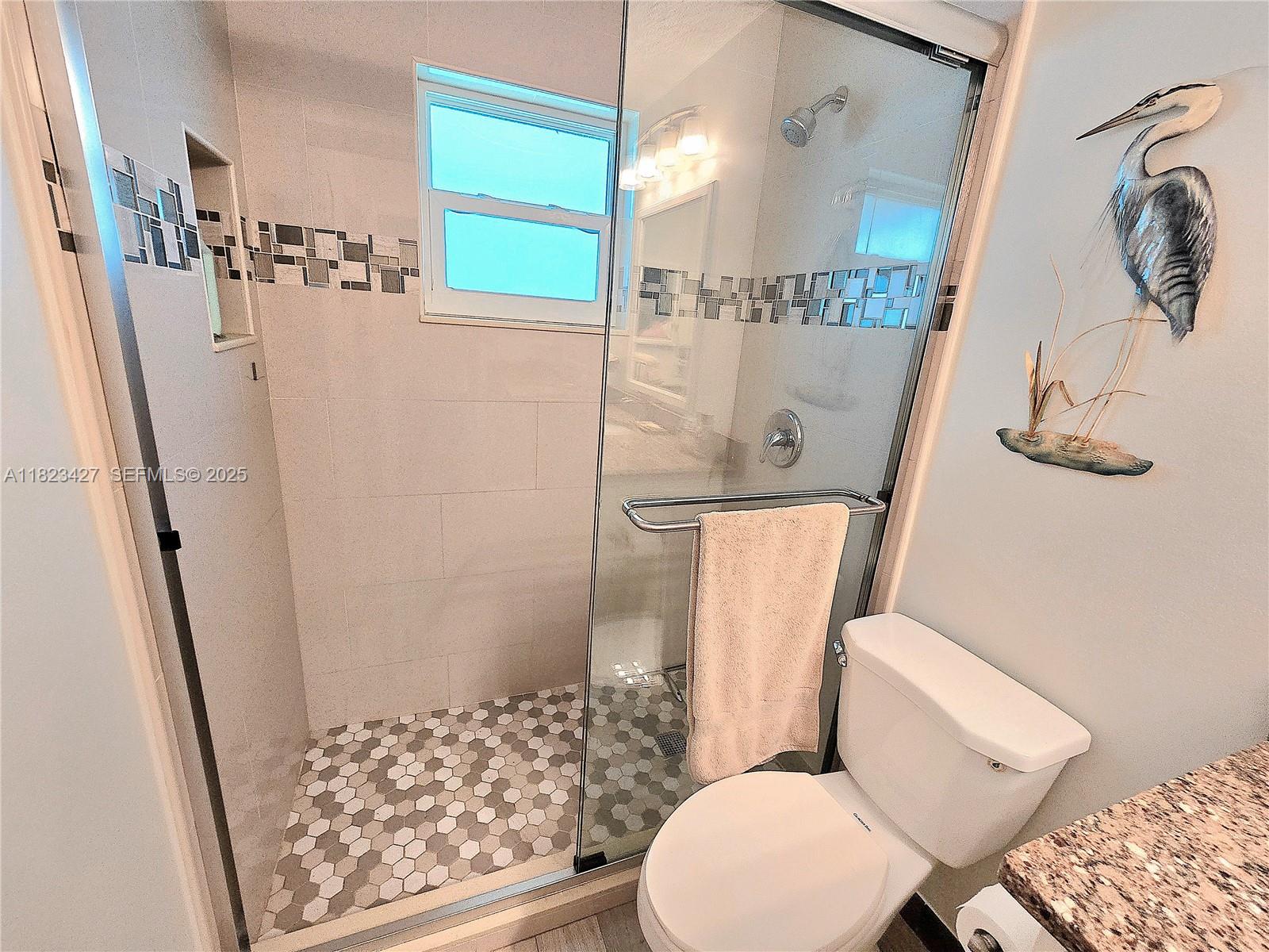 1711 Southwest 22nd Street Boynton Beach, FL 33426 - Photo 39 of 60 a bathroom with a toilet and shower