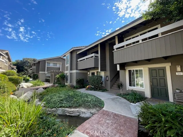 a front view of a house with yard and green space