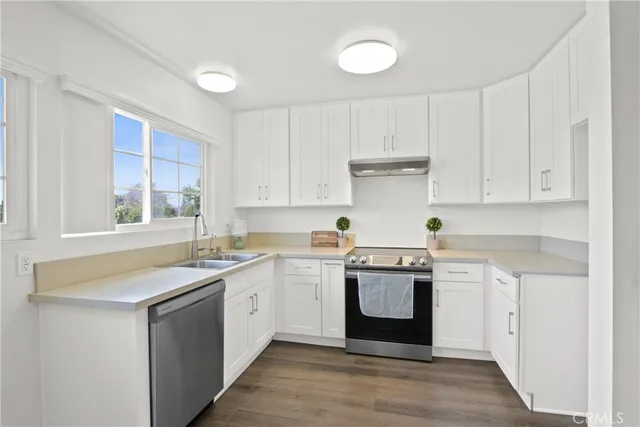 a kitchen with a sink stove and cabinets