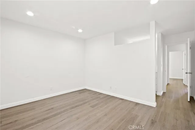 a view of a room with wooden floor