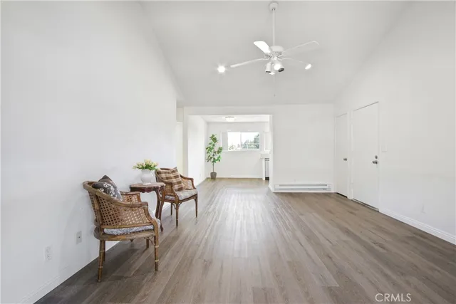 a view of a room with wooden floor and dining room