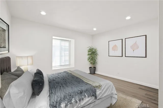 a spacious bedroom with a large bed and a window