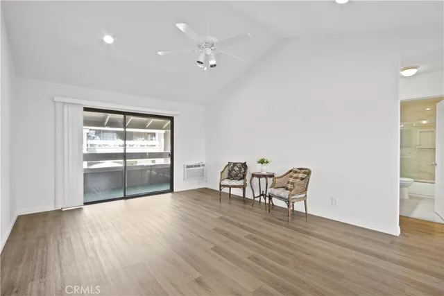 a view of a room with wooden floor and a cabinet