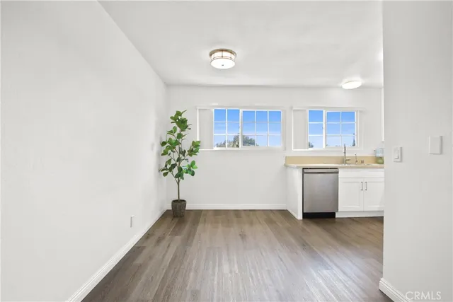 a kitchen with a wooden floor and a window