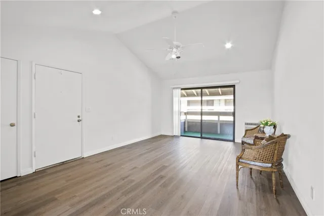 a view of a room with wooden floor and windows