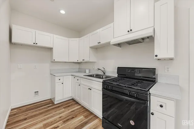 a kitchen with a stove a sink and a refrigerator