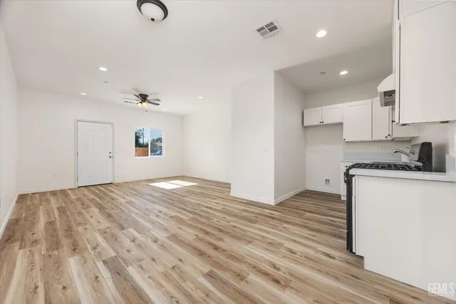a view of a room with a window and ceiling fan