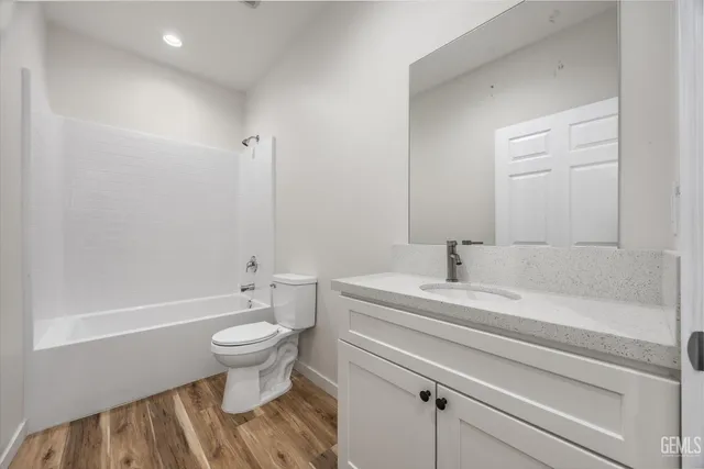a bathroom with a sink vanity and a toilet