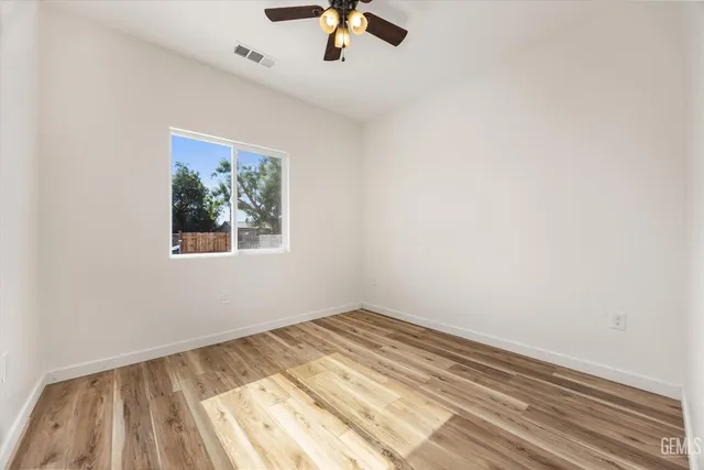 wooden floor in an empty room with a window
