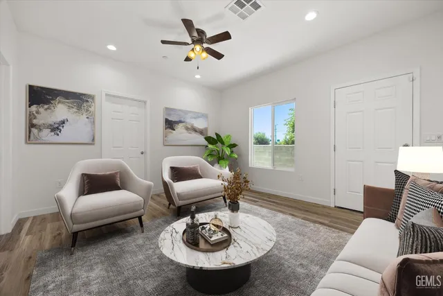 a view of a room with wooden floor and fan