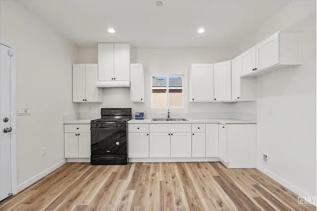 a living room with furniture kitchen view and a table