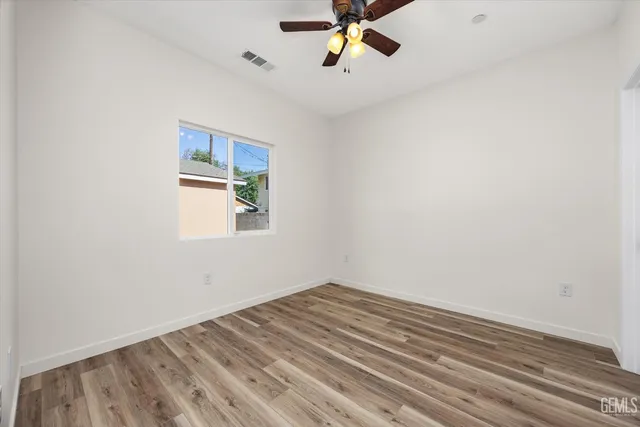 a view of a room with window and wooden floor