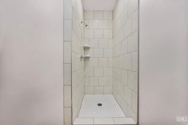 a large kitchen with a lot of counter space and wooden floor