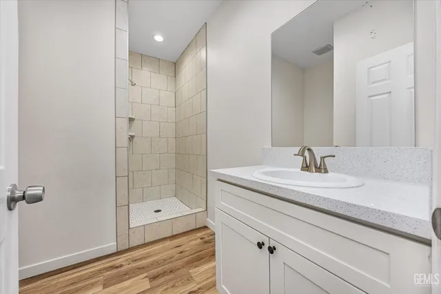 a kitchen with stainless steel appliances granite countertop a stove and white cabinets