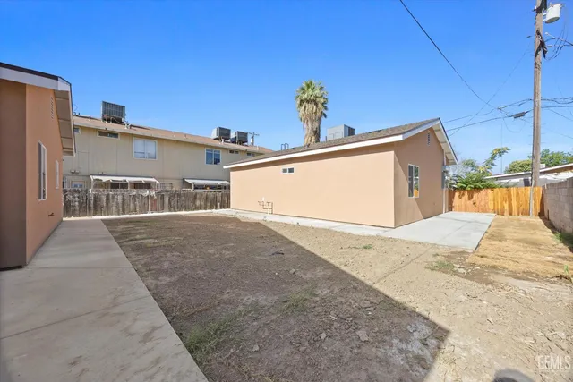 an empty room with a window and wooden floor