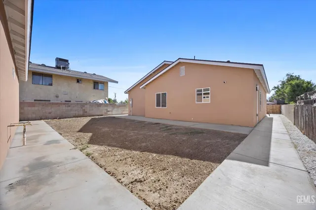 a bathroom with a granite countertop sink a toilet and a bathtub