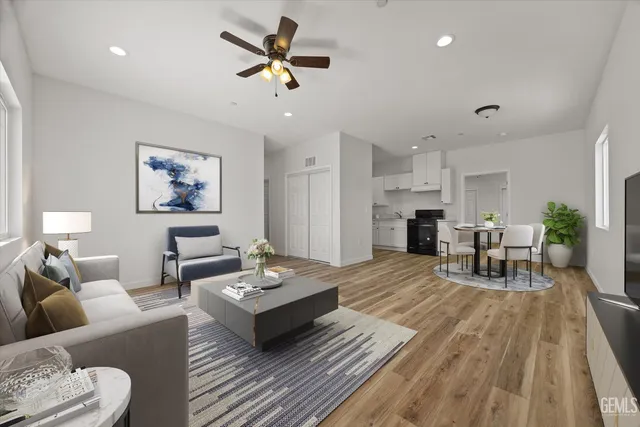 a living room with furniture and a wooden floor