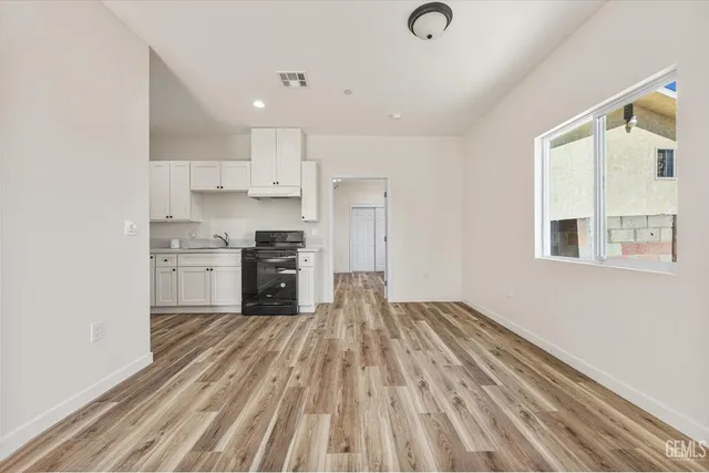a kitchen with cabinets stainless steel appliances and a counter space
