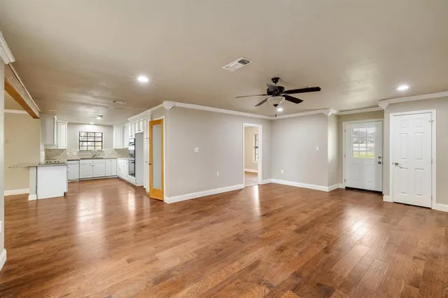 a view of an empty room and wooden floor