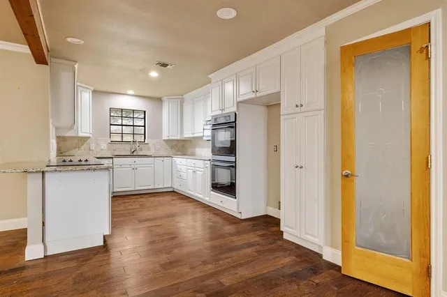 a kitchen with a refrigerator and a sink