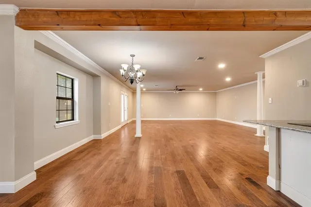 a view of a room with wooden floor