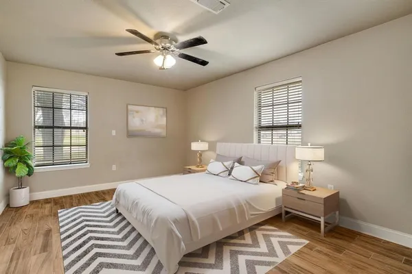 a bedroom with a bed and wooden floor