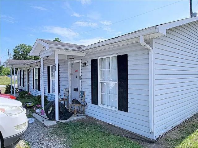 a view of a porch with furniture and a yard