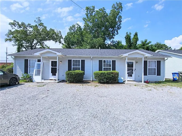 a front view of a house with a garden